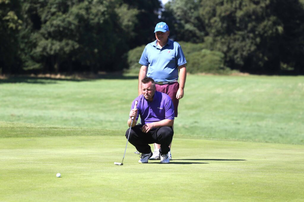 standing behind player putting