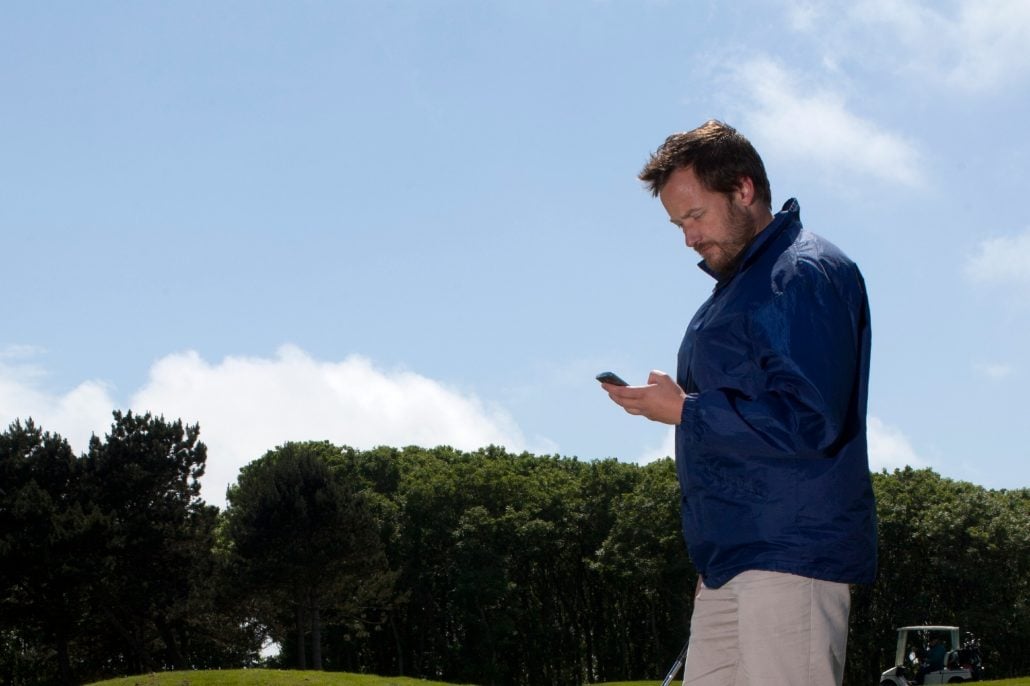 A golfer looks at their phone on the course. Is there too much golf technology?: Source: Supplied
World Handicap System