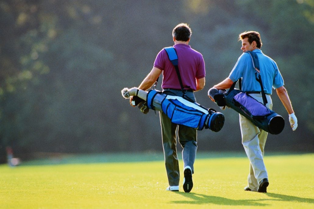 Two golfers walking the fairway