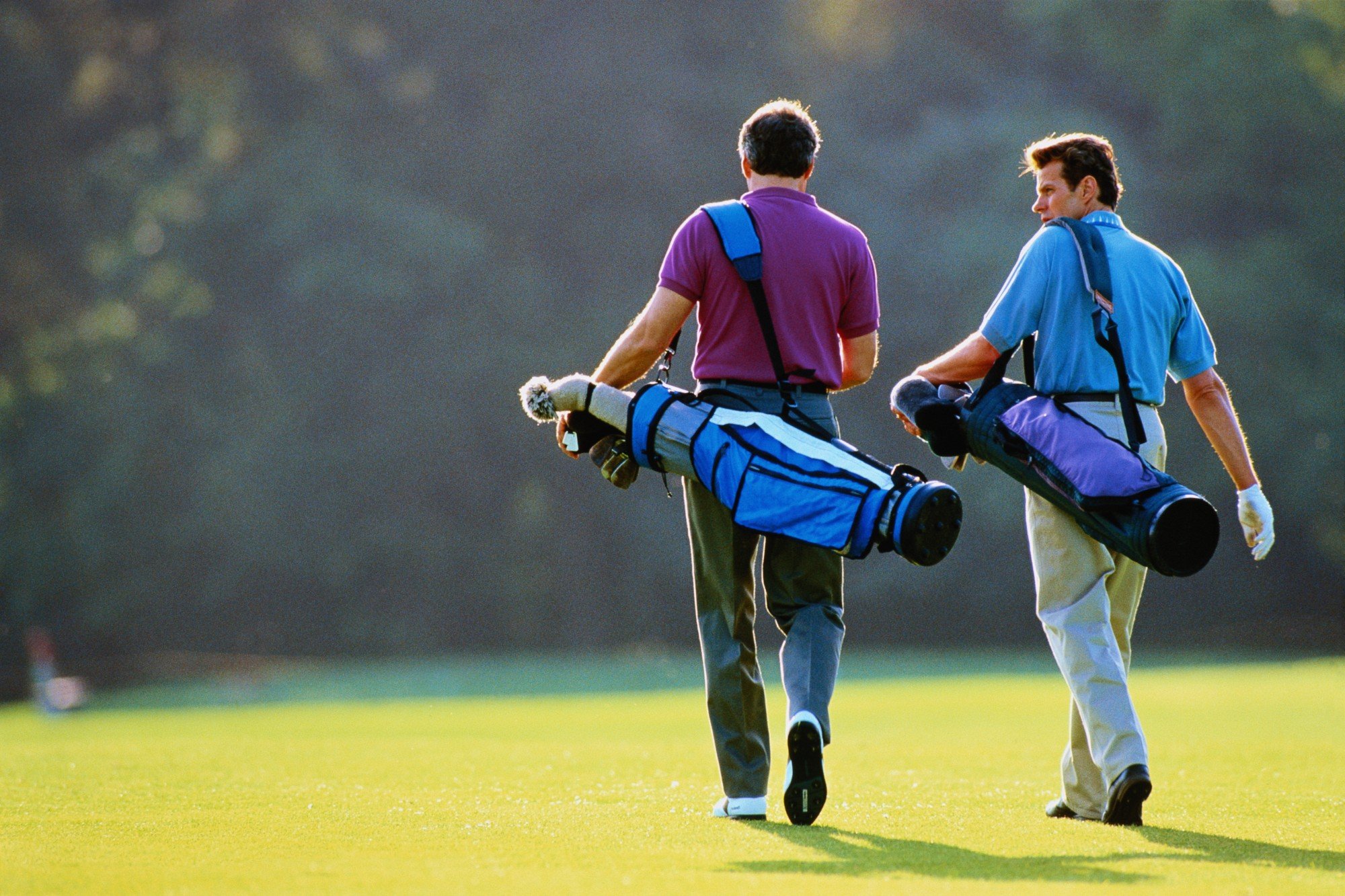 Two golfers walking the fairway