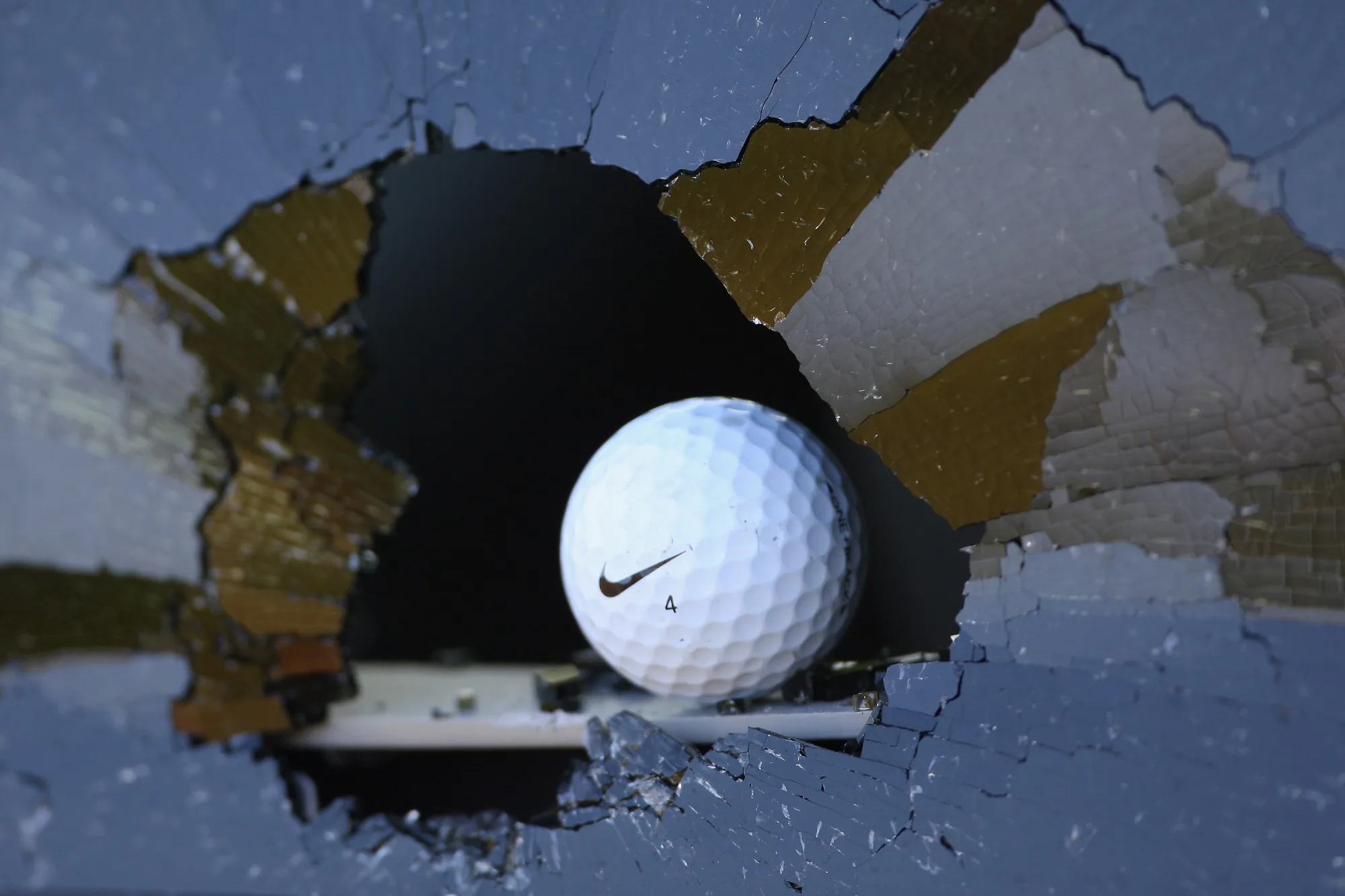 Golf ball smashed through window