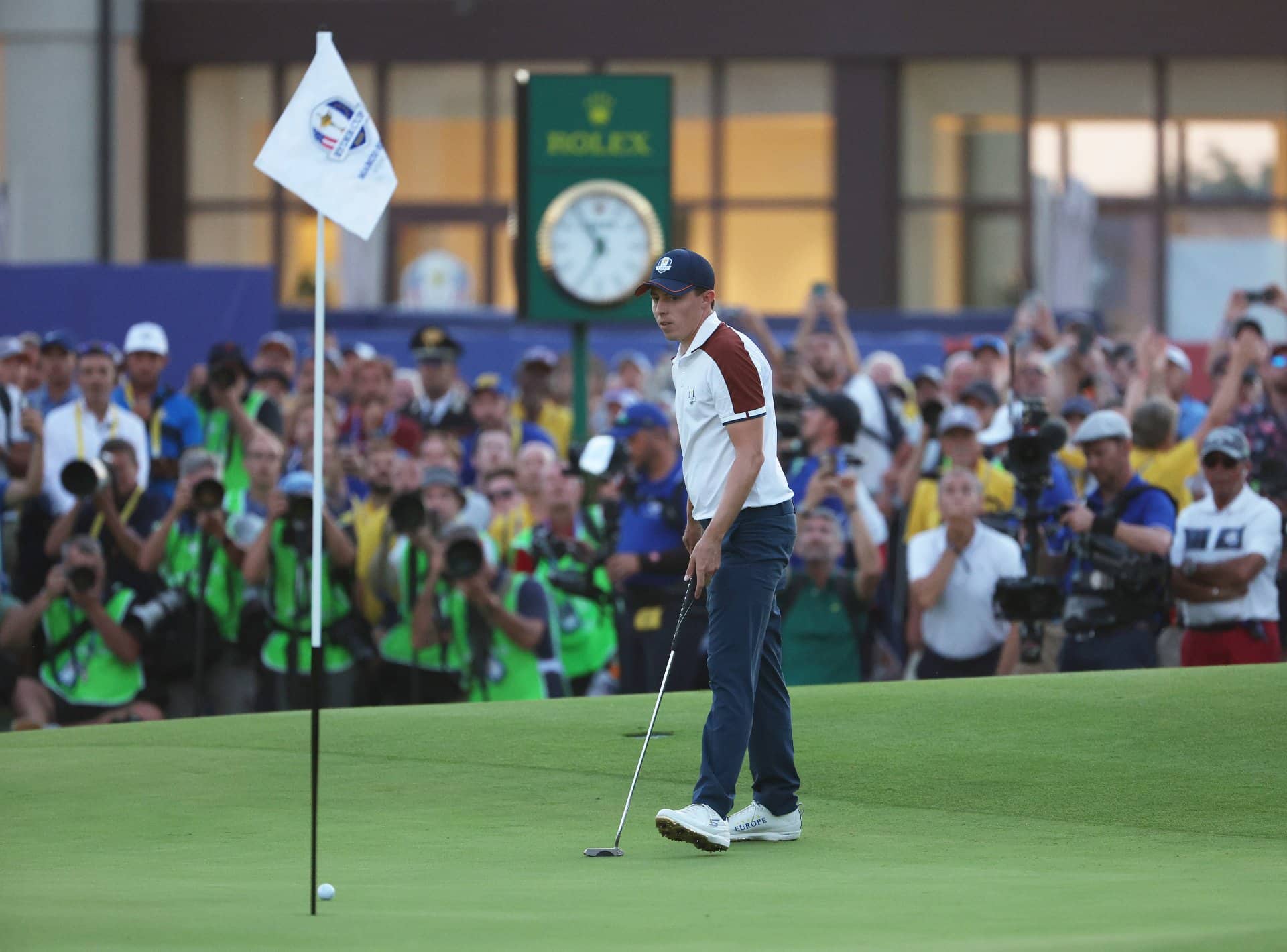 What do you do with the golf flagstick when putting?