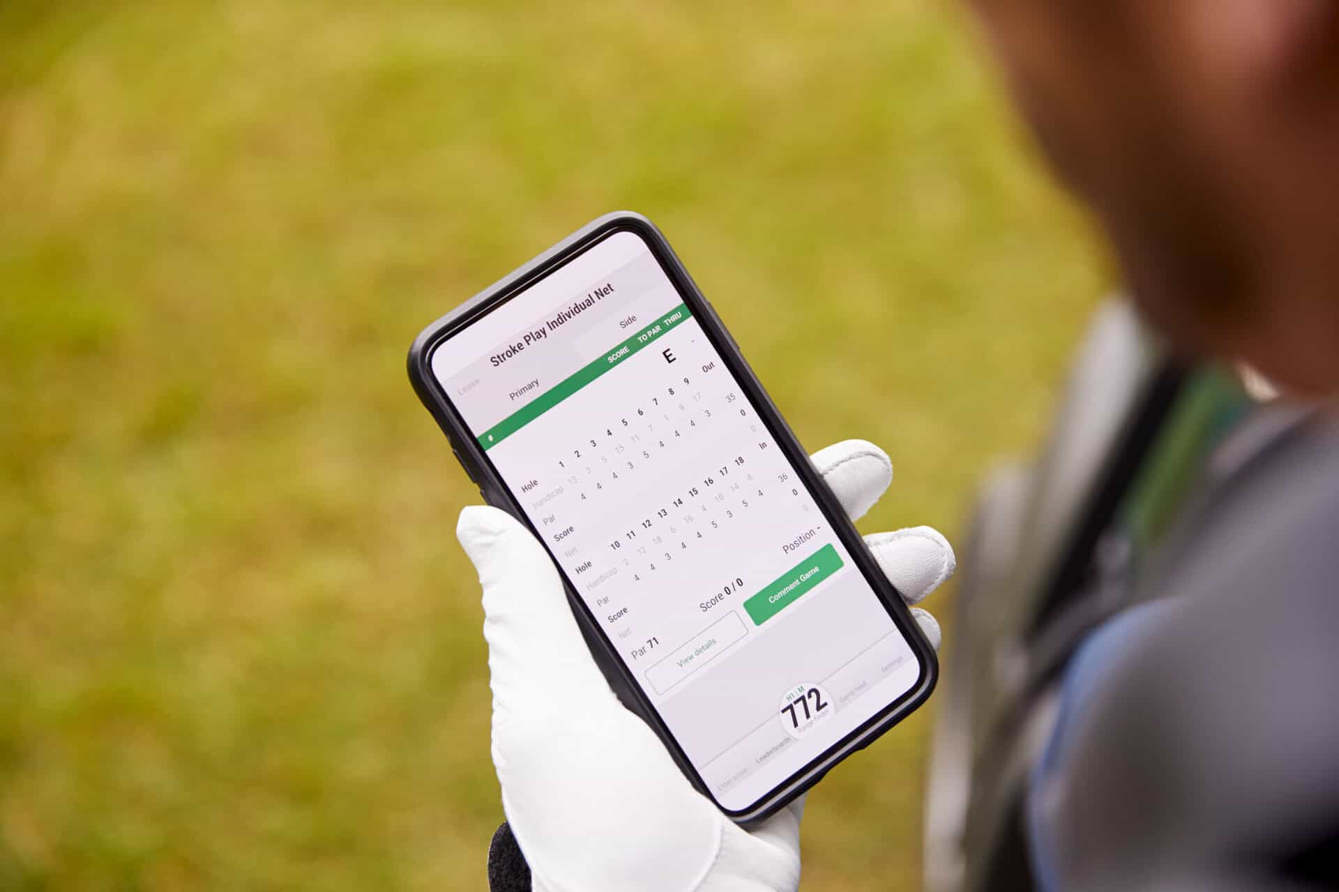 A golfer checks their score on a mobile phone app | Source: Adobe Stock