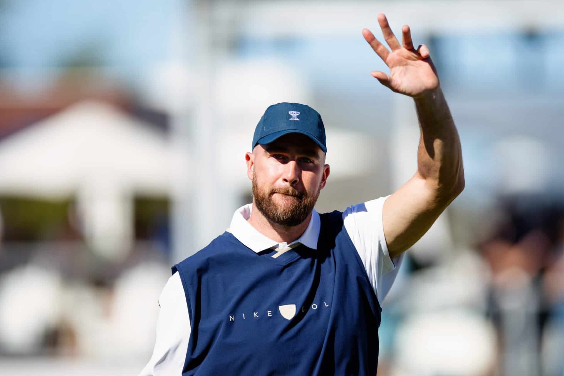 NFL star Travis Kelce waving on the course during a tournament.