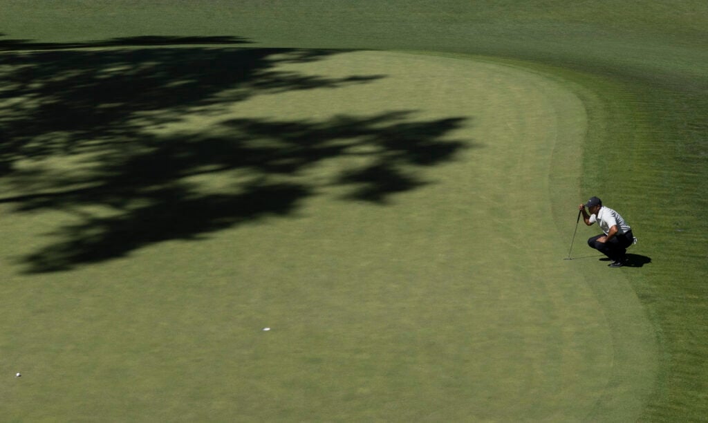 Masters champion Tiger Woods of the United States lines up a putt on the No. 10 green during the third round of the 2024 Masters Tournament at Augusta National Golf Club, Saturday, April 13, 2024. | source: Augusta National