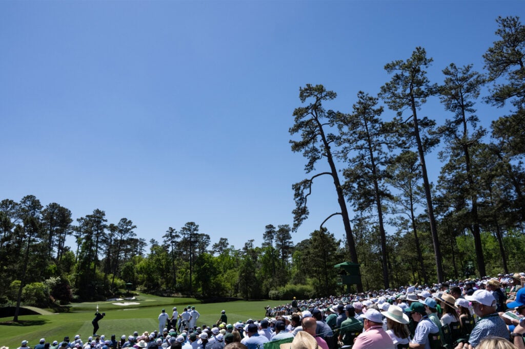 Huge crowds watch on as McIlroy hits his tee shot into the iconic par three, 12th at Augusta. Credit: Getty Images