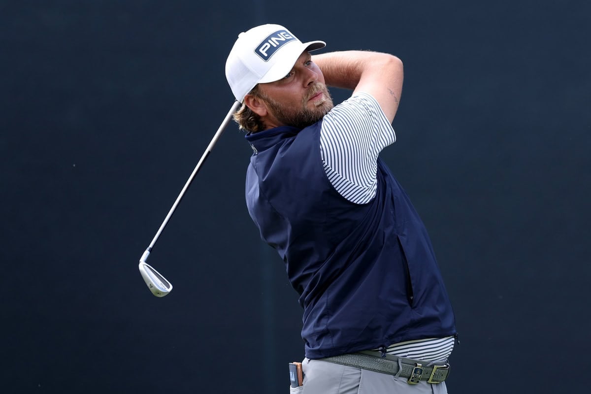 NEWTOWN, PENNSYLVANIA - MAY 14: Dan Brown of England plays his shot from the 14th tee during the first round of the PGA Championship at Aronimink Golf Club on May 14, 2026 in Newtown, Pennsylvania. (Photo by Richard Heathcote/Getty Images)