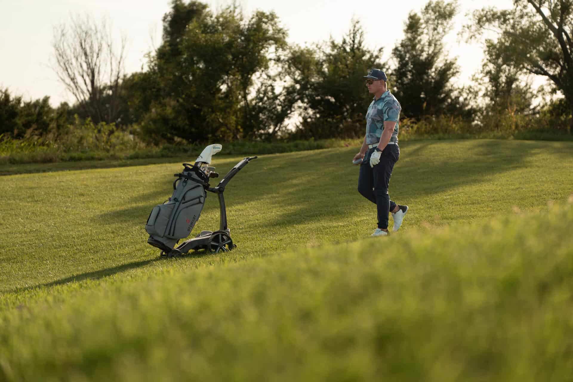 A golfer walking their round with a Stewart Golf trolley | Source: Stewart Golf