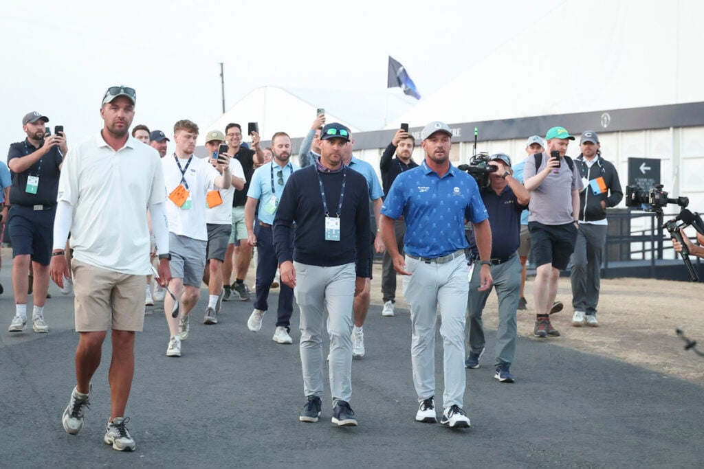 Bryson DeChambeau and his agent Brett Falkoff depart scoring after DeChambeau was assessed a two-stroke penalty on day two of The 154th Open Championship at Royal Birkdale | Source: Michael Reaves/Getty Images
