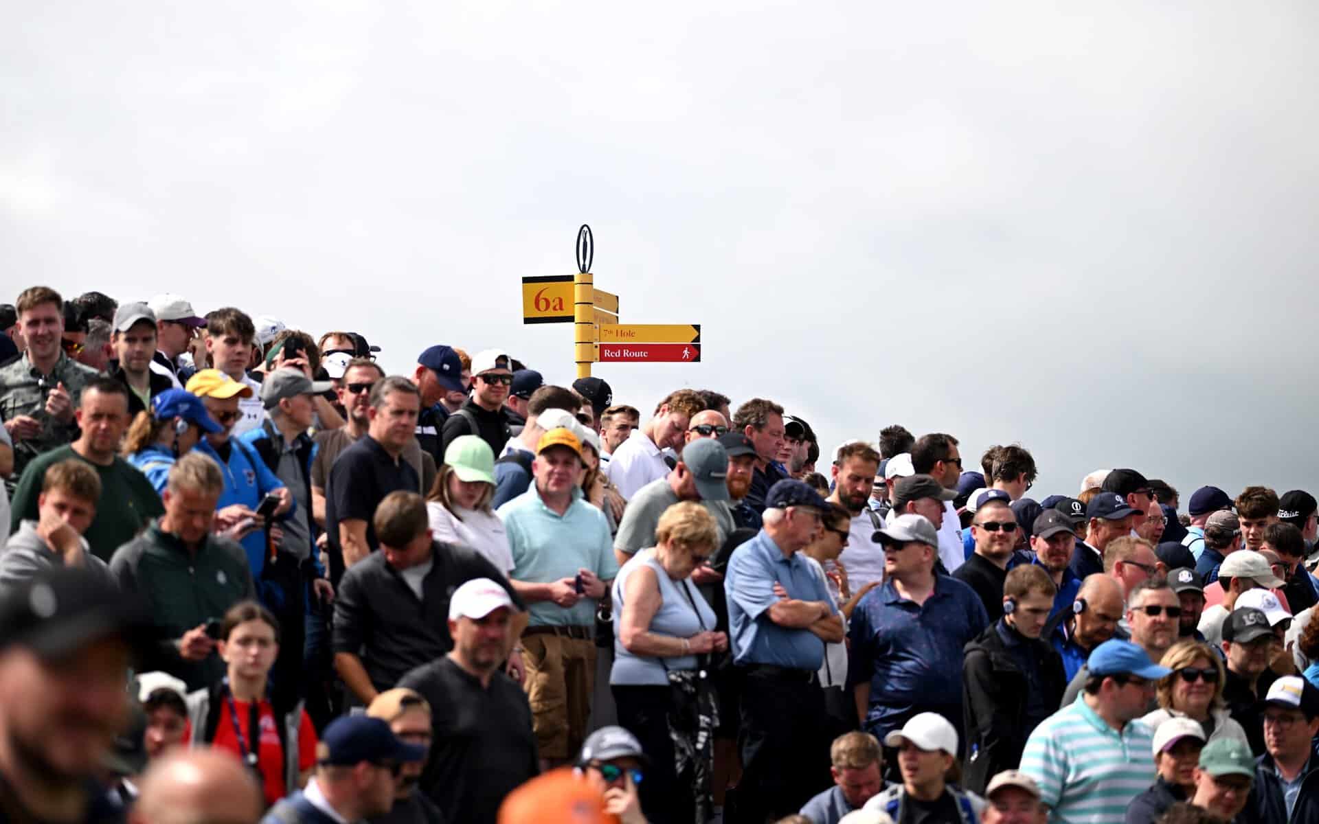 Crowds look on during The Open at Royal Portrush | Source: The R&A/via Getty Images spectator picks up golf ball