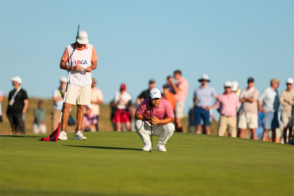 Tom Kim lines up his putt on the 13th hole green during the third round of the 2026 U.S. Open at Shinnecock Hills Golf Club in Southampton, N.Y. on Saturday, June 20, 2026 | Source: Kathryn Riley/USGA