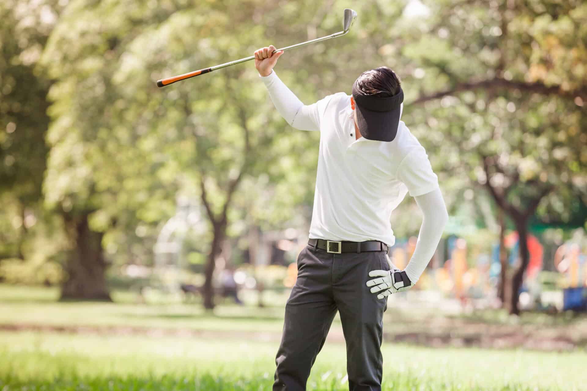 A frustrated golfer swing their club on the course | Source: Adobe Stock