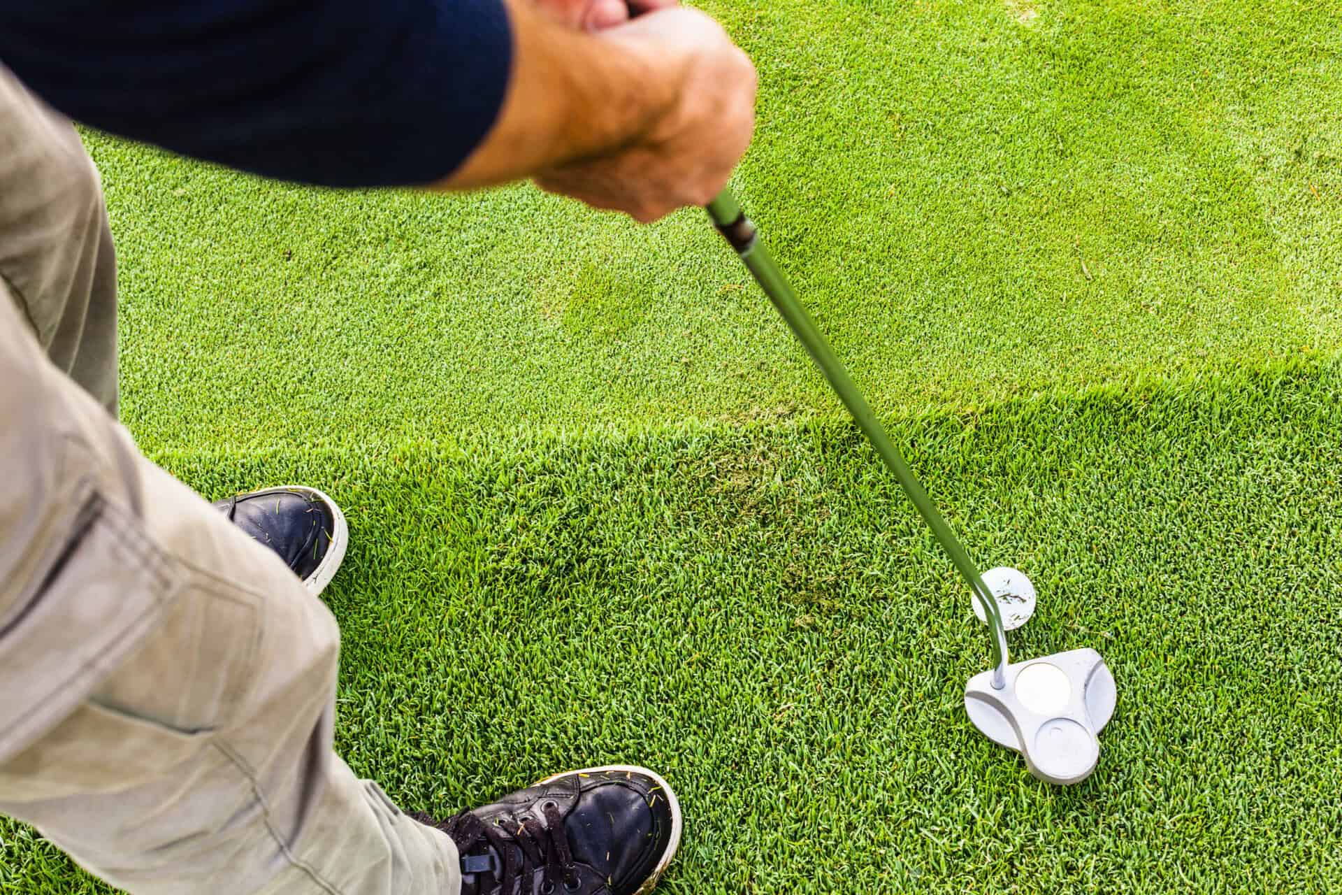 A golfer putts from the fringe | Source: Adobe Stock