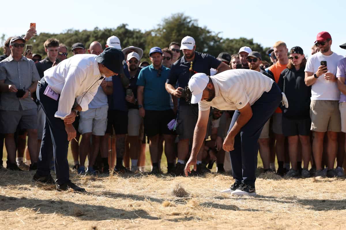 SOUTHPORT, ENGLAND - JULY 19: Scottie Scheffler of the United States speaks to rules official on the 17th hole on day four of the The 154th Open Championship at Royal Birkdale on July 19, 2026 in Southport, England. (Photo by Richard Heathcote/Getty Images)