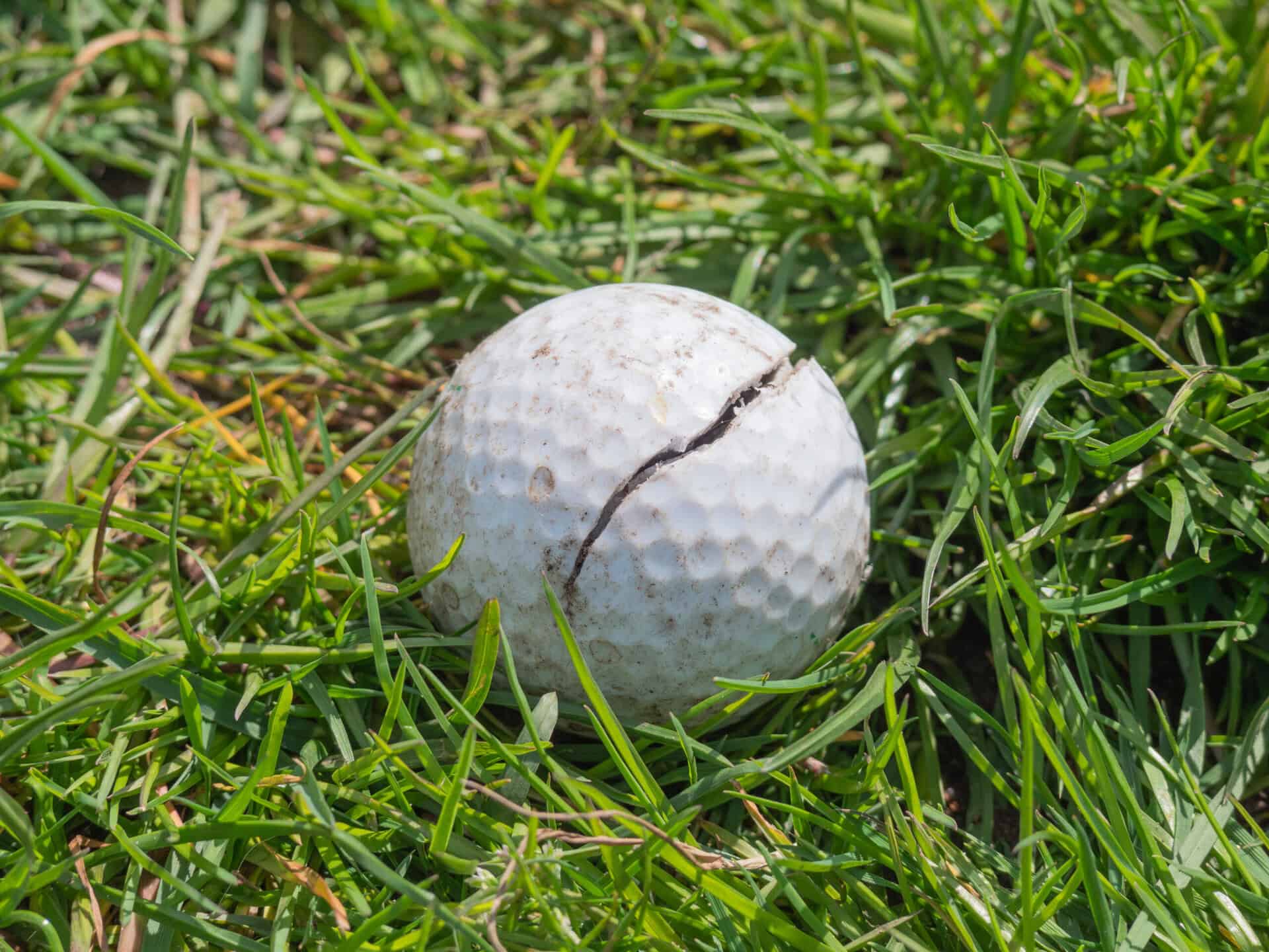 A cracked golf ball | Source: Adobe Stock