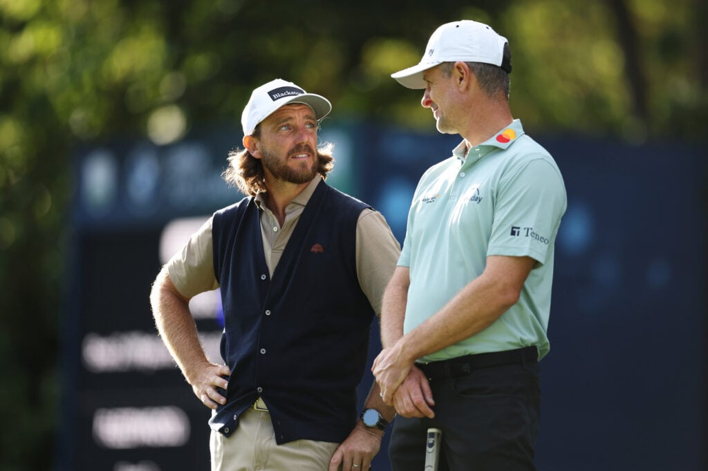 VIRGINIA WATER, ENGLAND - SEPTEMBER 17: Tommy Fleetwood of England and Justin Rose of England speak on the 16th green on day one of the BMW PGA Championship at Wentworth Golf Club on September 17, 2026 in Virginia Water, England. (Photo by Richard Heathcote/Getty Images)