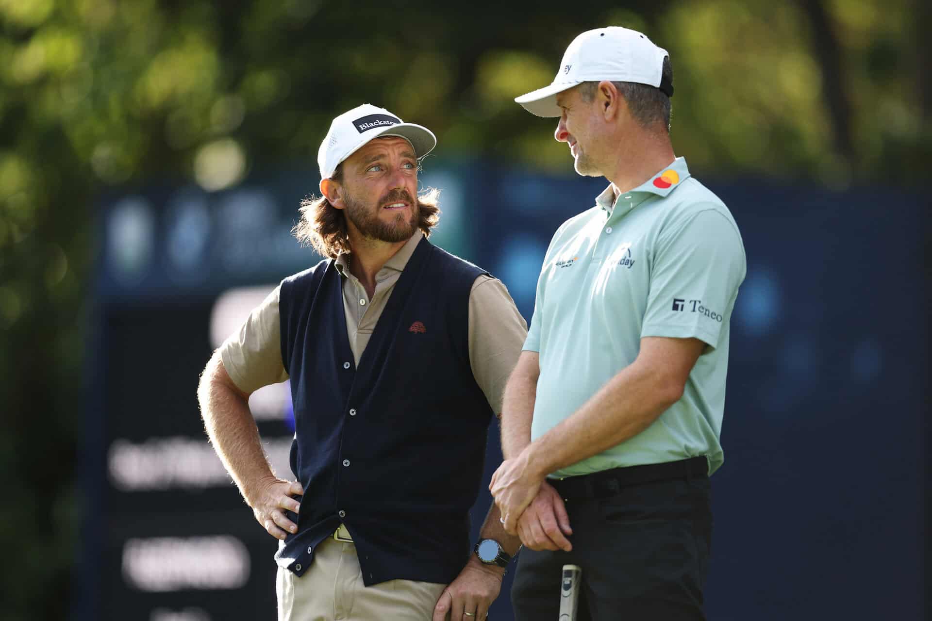 VIRGINIA WATER, ENGLAND - SEPTEMBER 17: Tommy Fleetwood of England and Justin Rose of England speak on the 16th green on day one of the BMW PGA Championship at Wentworth Golf Club on September 17, 2026 in Virginia Water, England. (Photo by Richard Heathcote/Getty Images)